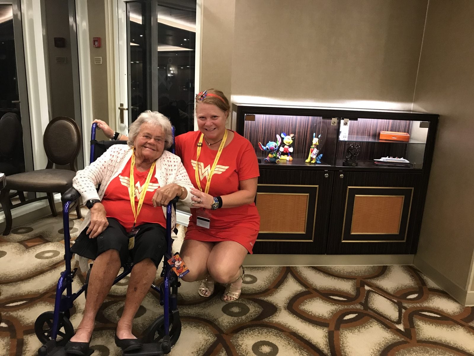 Ellen and her Mom on the cruise ship posing in wonder woman t-shirts